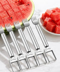 5 stainless steel 2-In-1 Watermelon Fork Cutters beside cubed watermelon, showcasing dual head knife and fork design on marble surface.