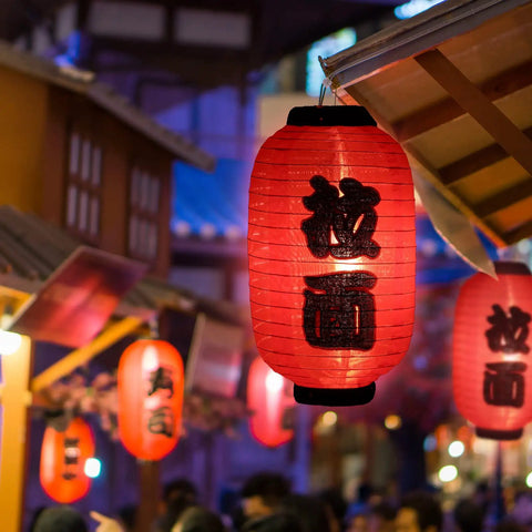 Japanese Style Red Silk Lanterns 14 Inch Traditional Hanging Lamps Waterproof Indoor Outdoor Festival Decor Izakaya Tavern Vibe Reusable Set Of 4 For Home Yard Patio Bar Parties illuminating a night scene.