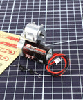 180 Motor 32T Transmission Metal Gearbox Combo for FCX24 Smasher V2 with wires and screws on grid surface.