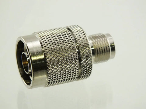Reverse Polarity TNC Female To N Male RF Adapter with gold plated pin and nickel plated body, close-up view.