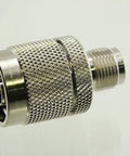 Reverse Polarity TNC Female To N Male RF Adapter with Teflon insulator, gold plated RF pin, nickel plated body, close-up view.