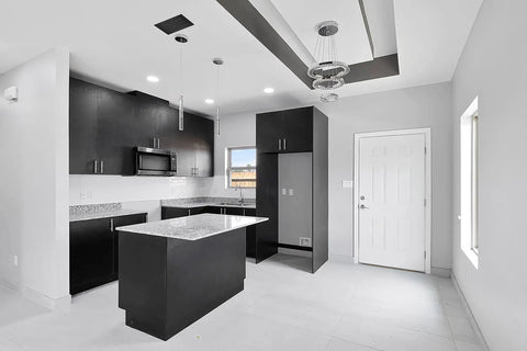 Modern kitchen with black cabinets and island, featuring a 12x10 modern AC vent cover decorative white air vent with standard linear slot diffuser.