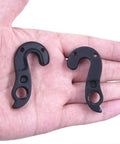 Hand holding two Derailleur Hanger 290 Dropout 475 Compatible With Giant Contend TCR Propel Forma Idiom Langma Liv Advanced CNC Aluminum Alloy Gear Mech Hanger Replacement With M3x8 Screws High Strength Durable Bike Parts