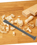 Heavy Duty Mason Chisel And Drawknife Wielding Kickass Carbon Steel on wood shavings with wooden blocks for carving.