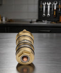 Real Deal 130156 Shower Valve Cartridge Replacement Featuring Heavy Duty 3 4 Inch Brass Core displayed on a stainless steel surface.