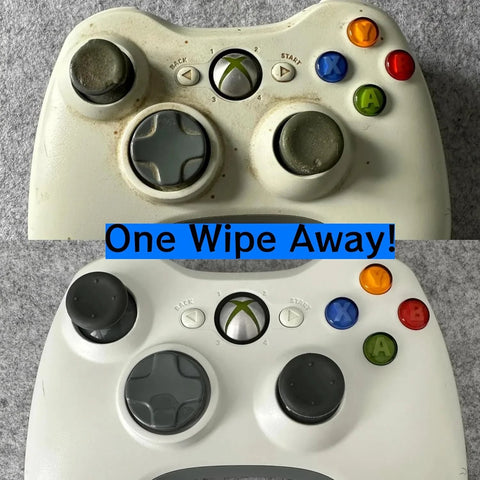 Two white Xbox 360 controllers, front views, worn thumbsticks and D-pads, blue One Wipe Away banner