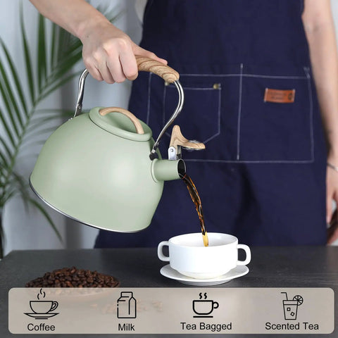 3 Liter Teapot With Loud Whistle Stainless Steel Stove Top Kettle With Wood Pattern Folding Handle Green Food Grade Teapot For Tea Lovers Coffee Buffs And Milk On The Stove Perfect For Daily Tea Or Coffee Rituals shown pouring liquid into cup held by person in apron.