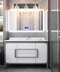 Three Light Black Metal And Crystal Vanity Light Fixture in modern bathroom above white sink and mirror setup