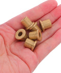 Six Piece Flanged Copper Sleeve Bearings With Step Shoulder Flange And Wrapped Brass Bushings in hand, showing sizes and details.