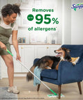 Person using 2-In-1 Floor Mop And Sweeper Starter Kit With 1 Mop And 19 Refills near dog on chair, removes allergens.