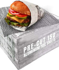 Stack of pre-cut 150 aluminum foil sheets with a wrapped burger on top, 10.75 x 14 inches, keeps food warm or cold longer.