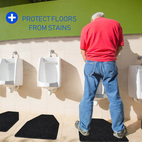 Man using urinal with 10 Pack Urinal Mats For Men Non Slip Urinal Floor Mats For Commercial Restrooms Highly Absorbent Durable With Waterproof TPR Backing Keeps Urinal Floors Dry And Slip Free Black visible on floor.