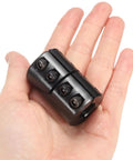 Rigid Single Split Shaft Coupling For One-Half To Three-Eighths Inch Bore, black oxide coated, shown on a human hand for scale.