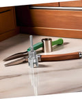 Upgrade Your Plumbing Game With This Awesome Dual-Function Pipe Thread Cutting Tool Kit on a countertop with pliers and a hammer.