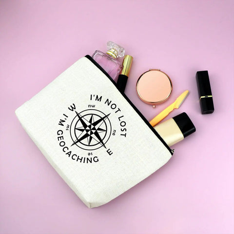 Im Not Lost Geocaching Gift Makeup Bag For Women Travel Essentials Zipper Pouch on pink surface with cosmetics