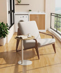 C Shaped Round End Table With Metal Legs For Couch in rustic oak beside a cozy chair on a wooden floor near a window.