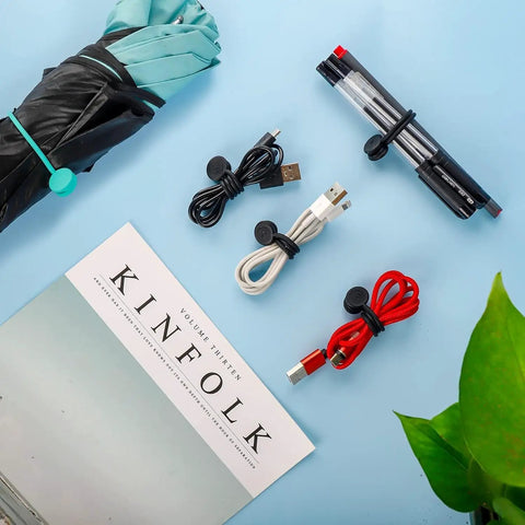 Cord Organizer And Cable Ties Set With Super Handy Magnetic Clips holding pens, cables, and umbrella, 12 Pack Black displayed.