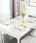 Clear Desk Protector 1.5mm Thick 14 By 24 Inches Heavy Duty Vinyl Desk Pad on a white dining table set with plates and cutlery.