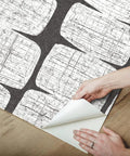 Hands peeling Mid Century Beads Peel And Stick Wallpaper In Black And White, Self-Adhesive Removable Paper for installation