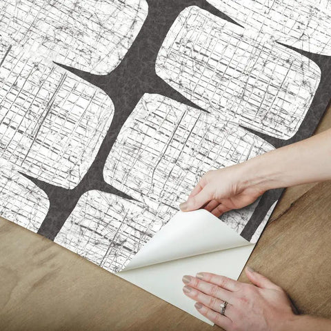 Hands peeling Mid Century Beads Peel And Stick Wallpaper In Black And White, Self-Adhesive Removable Paper for installation