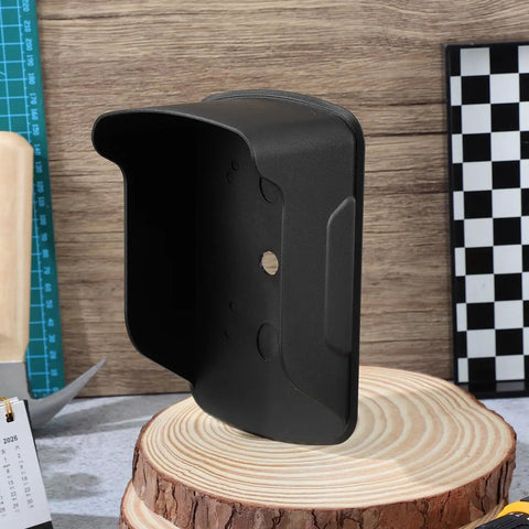 Black plastic Waterproof Doorbell Cover Rain Guard for outdoor devices shown on wooden surface, protects from elements.