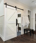 Black 4 Piece Barn Drawer Pulls Set With Flat Head Long Base Design installed on white sliding barn door in modern bathroom