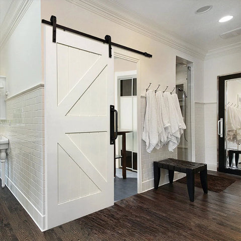 Black 4 Piece Barn Drawer Pulls Set With Flat Head Long Base Design installed on white sliding barn door in modern bathroom