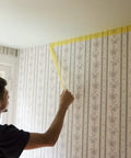 Person applying Delicate Surface Painters Tape With PaintBlock Technology For Clean Lines On Fresh Paint Pro Grade DIY Friendly