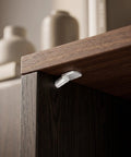 Beefy Spoon Shape Metal Shelf Pegs 60 Pack 7mm Nickel Plated Shelf Pins holding up a shelf in a dark wood cabinet