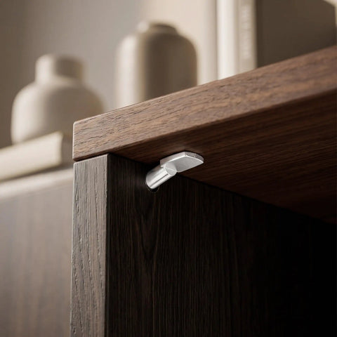 Close-up of nickel-plated spoon-shaped shelf peg pin installed in a wooden cabinet for heavy-duty shelving.