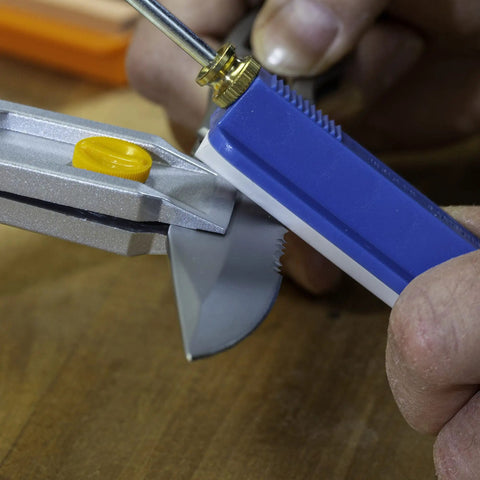 All In One Knife Sharpening Kit That Seriously Handles 6 Stones For Straight And Serrated Blades angle guide in use