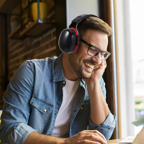 Smiling man wearing Kick Loud Noise To The Curb With Double Layer Over Ear Earmuffs designed for construction and shop jobs.