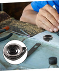 Coil Spring For Mechanical Clock Repair And Vintage Alarm Clock Quill Spring Assembly on workbench with tools.