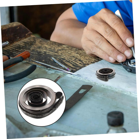 Coil Spring For Mechanical Clock Repair And Vintage Alarm Clock Quill Spring Assembly on workbench with tools.
