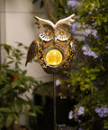 Solar Owl Garden Stake Lights For Lawn And Pathway, bronze crackled glass owl light with adjustable wings in a garden setting