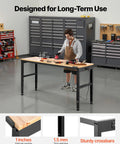 Person working on Heavy Duty Adjustable Workbench With 2000 Lb Capacity 61 By 20 Inch Surface Height Adjustable From 27.1 To 36 Inches Built In Power Outlets Perfect For Garage Shop Or Office in a garage setting.
