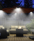 Outdoor patio illuminated by hanging LED lights from an umbrella, showcasing a garden seating area with a wooden deck at night.