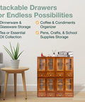Four Piece Stackable Mini Cupboard Set With Eight Drawers And Glass Doors In Dark Mahogany Wood For Pantry Kitchen Bath Or Garage Storage Fully Assembled And Ready To Organize next to a plant on a table.