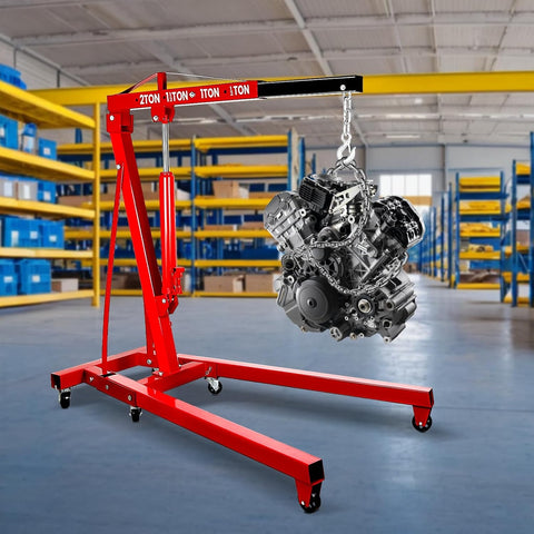 Built Tough Folding Engine Hoist With Quick Adjust Leveler And Rock Solid 6400 Lbs Alloy Steel Capacity, engine suspended in a garage.