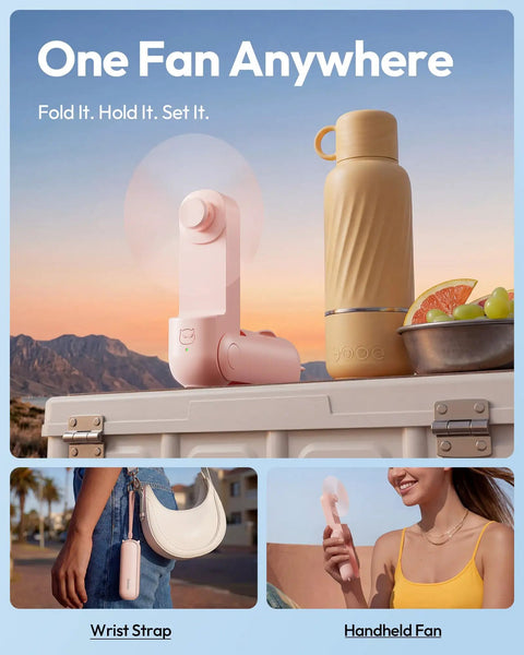 3 In 1 Portable Handheld Fan Foldable Lipstick Size USB Rechargeable Personal Cooler in pink, shown with a bottle and fruit on a table.