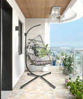 Outdoor Hanging Egg Chair With Stand For Patio And Garden Cozy Weatherproof Wicker Hammock Chair With Plush Cushion And Durable Steel Frame on balcony