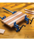 Beefy Extra Wide 3/4 Inch Pipe Clamps For Woodworking With 2-1/2 Inch Jaws holding wooden boards on a workbench
