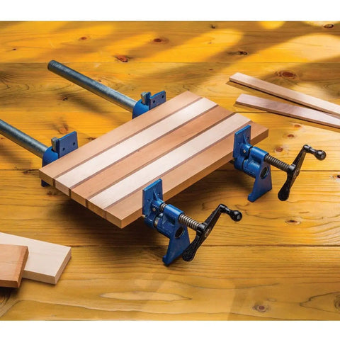 Beefy Extra Wide 3/4 Inch Pipe Clamps For Woodworking With 2-1/2 Inch Jaws holding wooden boards on a workbench