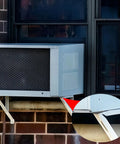 Outdoor AC condenser with Eight Pack Mini Split Anti Vibration Rubber Pads on wall mount, close-up of pad detail.