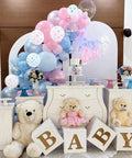 Pastel Pink and Blue Gender Reveal Balloons Set 60 Pack 12 Inch Includes 20 Pink 20 Blue 10 Pink Bow Print 10 Blue Bow Print Balloons Plus Ribbon for Easy Decorating Perfect for Baby Shower or Boy or Girl Reveal with plush bears and cake table