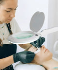 Hands Free LED Magnifying Glass With Adjustable Stand And Floor Lamp in use for precision lash extensions.