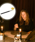 Telescopic Candle Fire Extinguisher With Extensible Copper Wick Snuffer For Home Safety on a table with candles and a woman.
