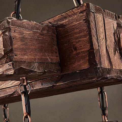 Close-up of Industrial Vintage Wooden Pendant Light With Glass Lanterns, Rustic wood grain and metallic chain details.