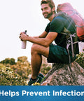 Person sitting outdoors with a backpack, holding a bottle. Text: 'Helps Prevent Infection.' Focus on outdoor protection and hygiene.