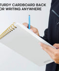 Person writing on To Do List Notepad For Work And Home, Undated Daily Planner With 52 Sheets, 9.8 by 6.5 inches, spiral-bound.